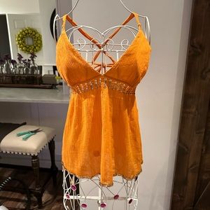 Woman’s orange backless, sequin shirt
